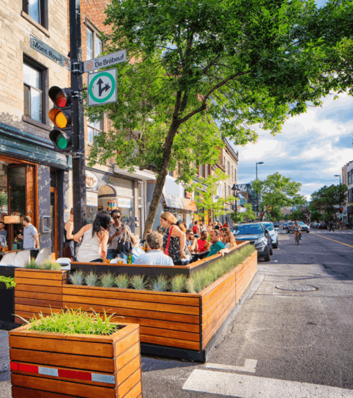 People enjoy themselves at a sidewalk cafe on Mont Royal Avenue in Montreal