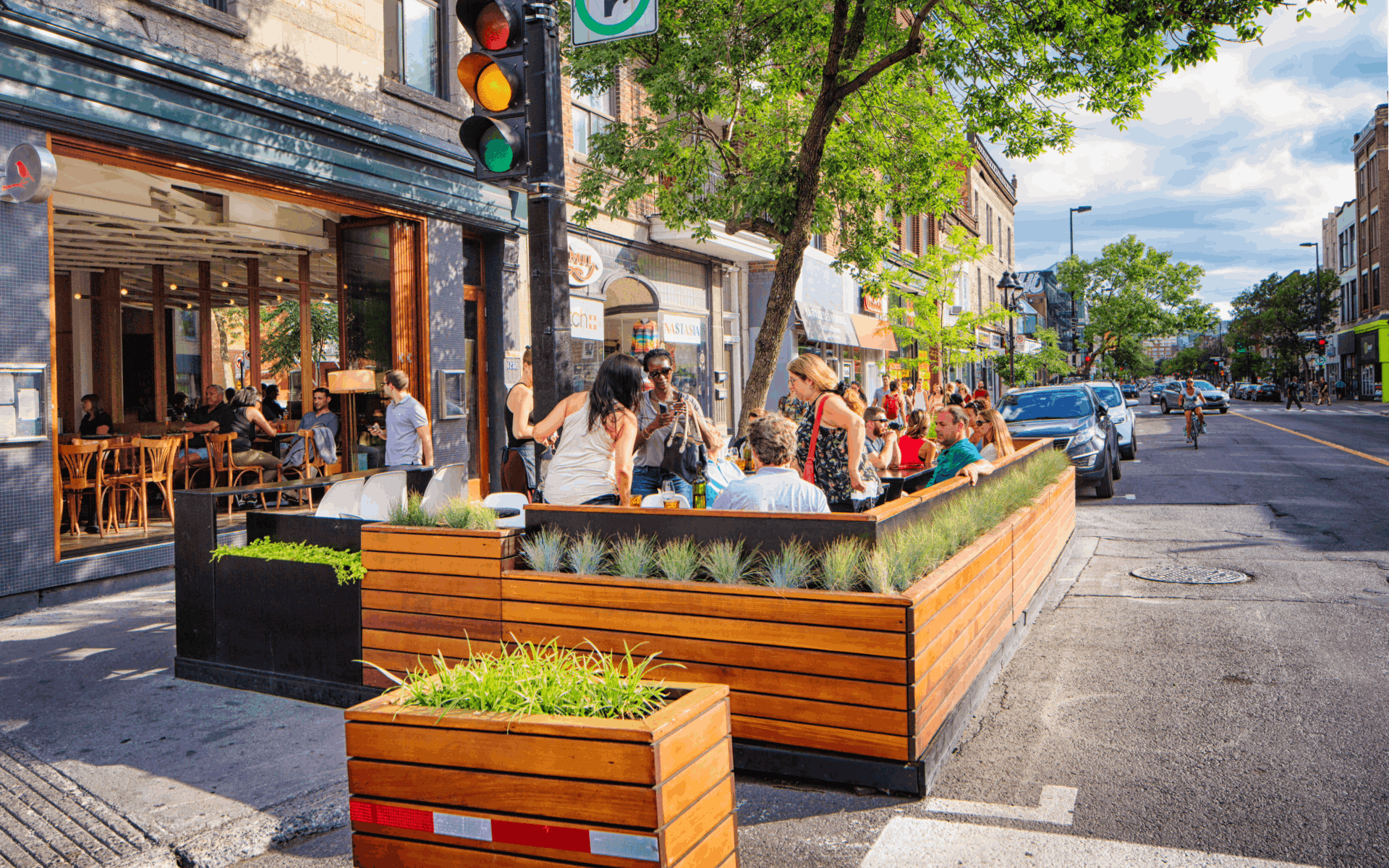People enjoy themselves at a sidewalk cafe on Mont Royal Avenue in Montreal