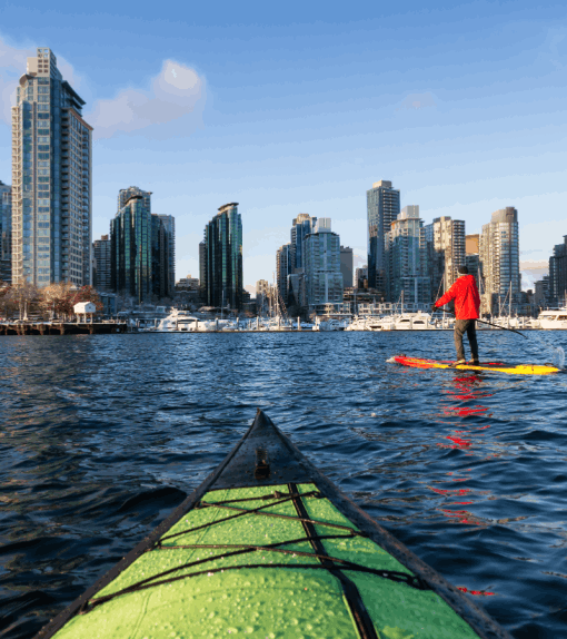 A kayak sails along the Vancouver harbour